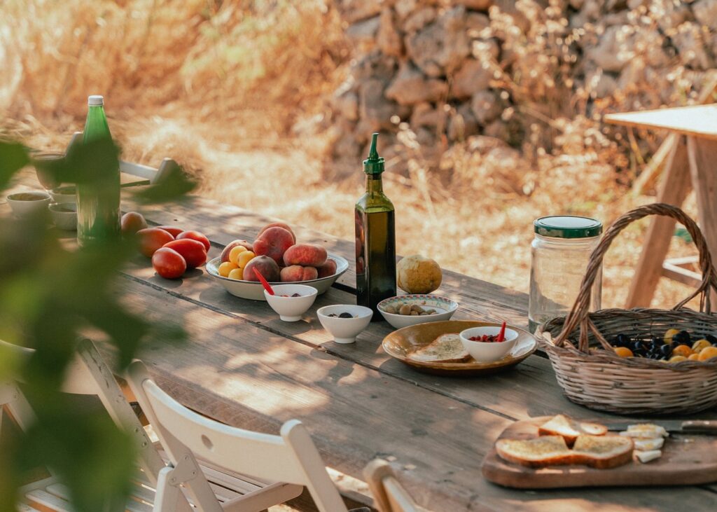 Farmhouse tasting table among olive trees at Three Farms Island, Val di Noto, eastern Sicily