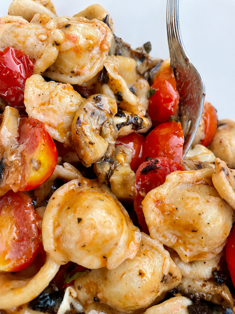 Mediterranean pasta salad with grilled eggplant, mozzarella, tomatoes and crispy black olives